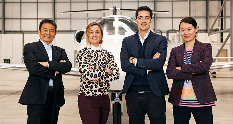 OXCCU management standing in front of aircraft