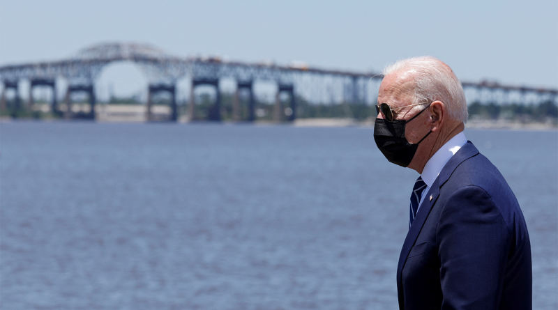 Biden walking past river with mask on to support LNG export ban article