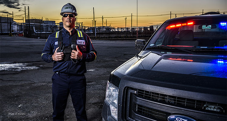 IMTT worker next to pickup truck infront of storage facility