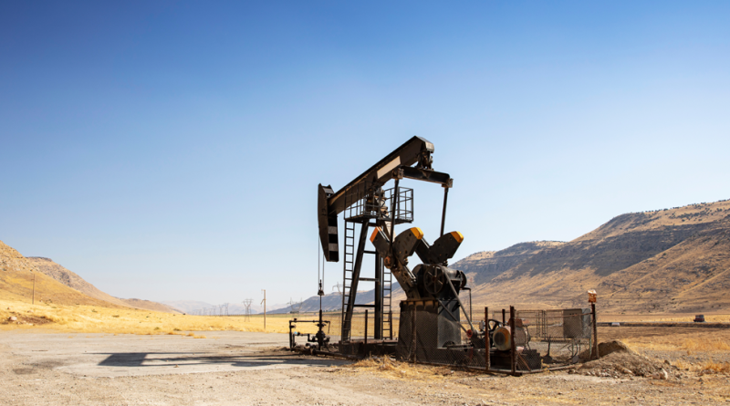 Oil drilling derricks at desert oilfield