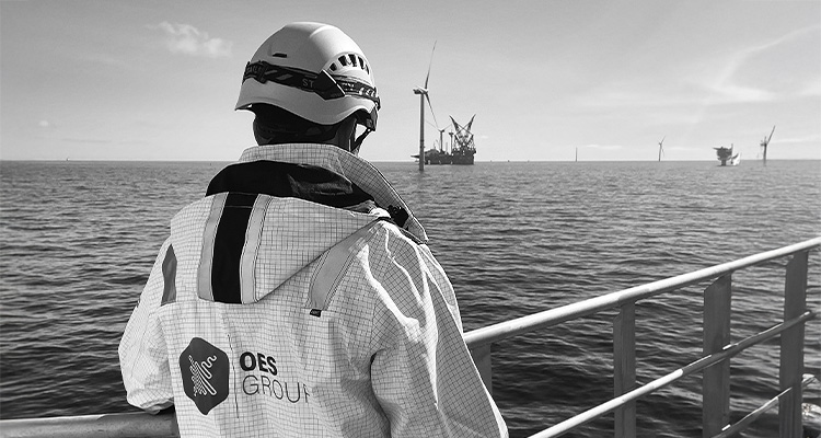 OES worker on a boat heading towards a wind farm