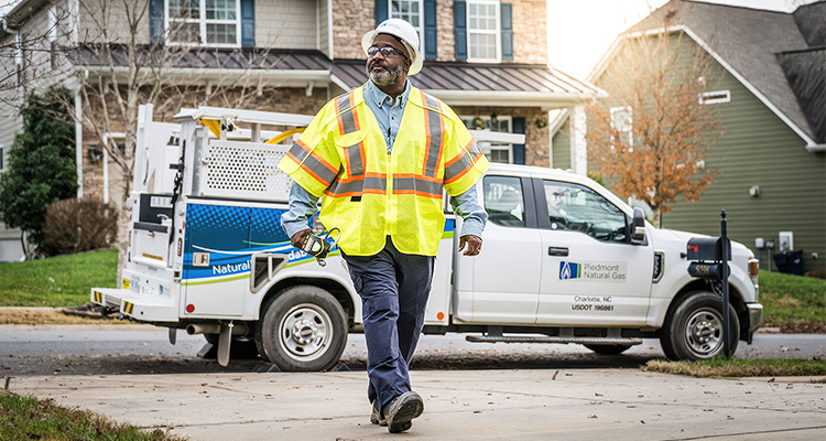 Piedmont Natural Gas worker in front of a company truck
