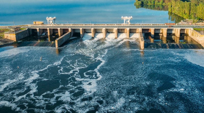Water flowing through hydroelectric dam turbines generating clean power