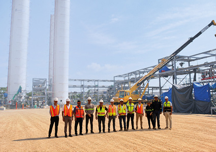 a team of workers on a large industrial construction site