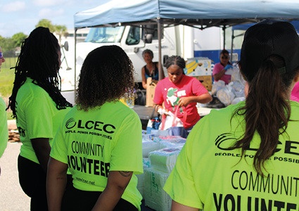 volunteers wearing bright neon green shirts provided by Lee County Electric Cooperative