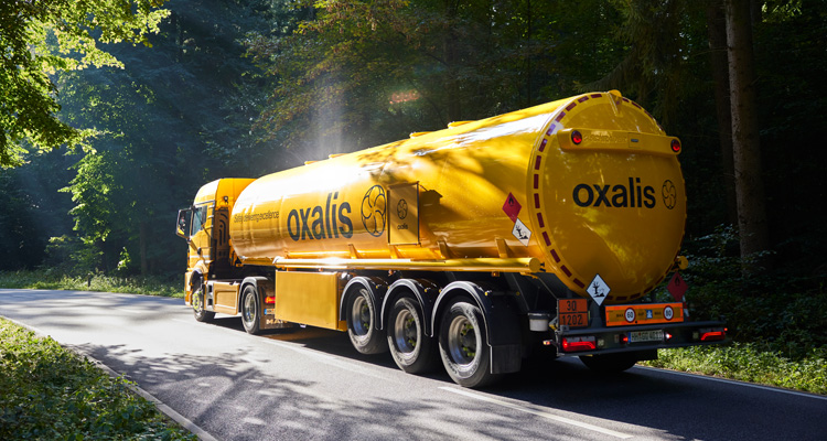 a yellow Oxalis Logistics tanker truck
