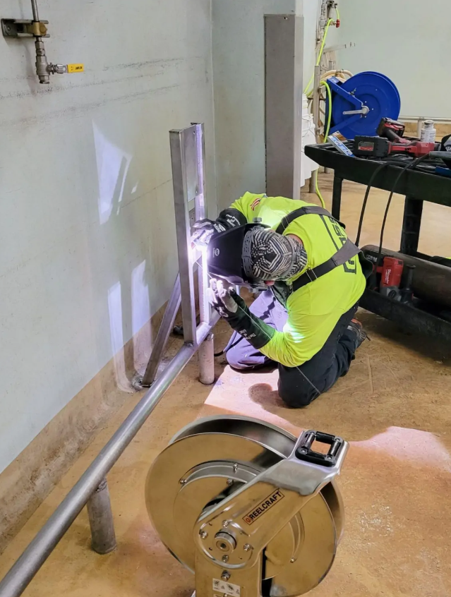 A welder from Foss General Contractors is busy with a chemical processing project.