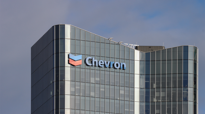 Chevron logo displayed on the exterior of the energy company’s modern glass office building.