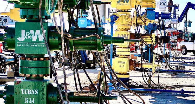 green and yellow wellhead and Christmas tree assemblies