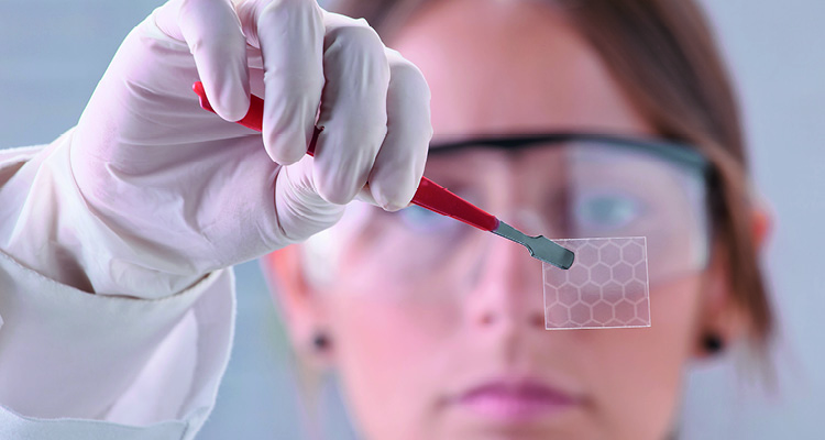 a researcher holding a sheet of graphene
